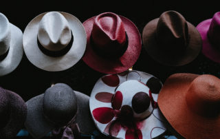 A photo of cowboy hats of multiple colors and designs